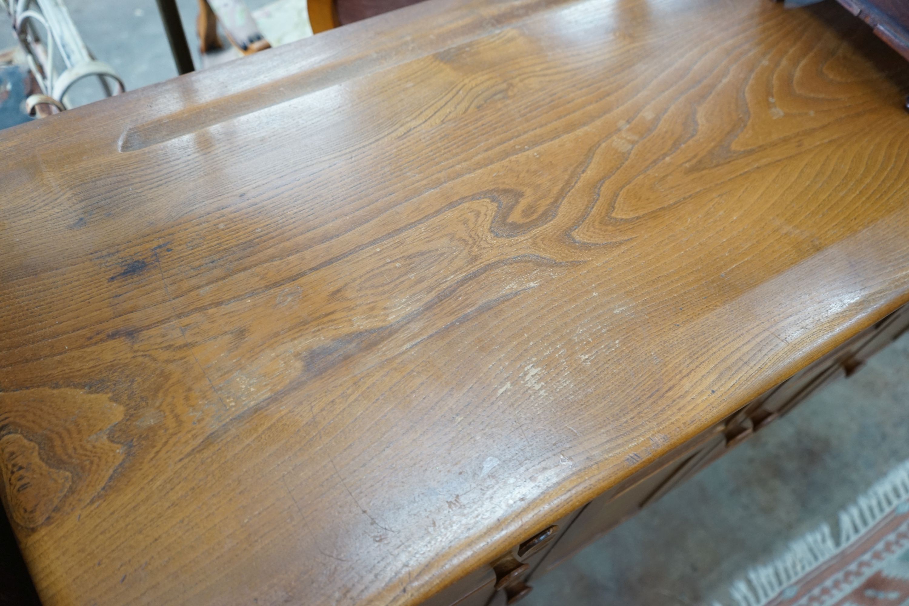 An Ercol elm sideboard, length 130cm, depth 49cm, height 86cm